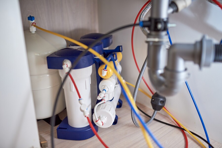 Under-sink reverse osmosis water filter system with colored tubing and plumbing connections